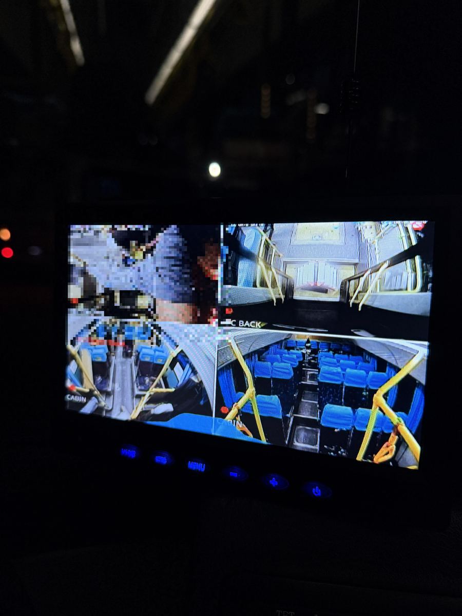 Technician checking camera output on a monitor inside the vehicle